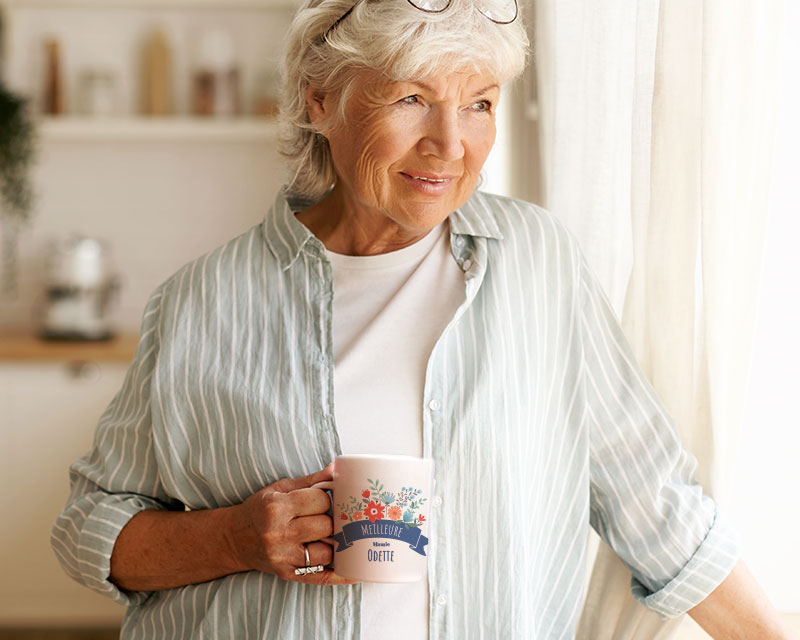 grand-mère qui tient un mug personnalisé mamie fleurie dans sa main