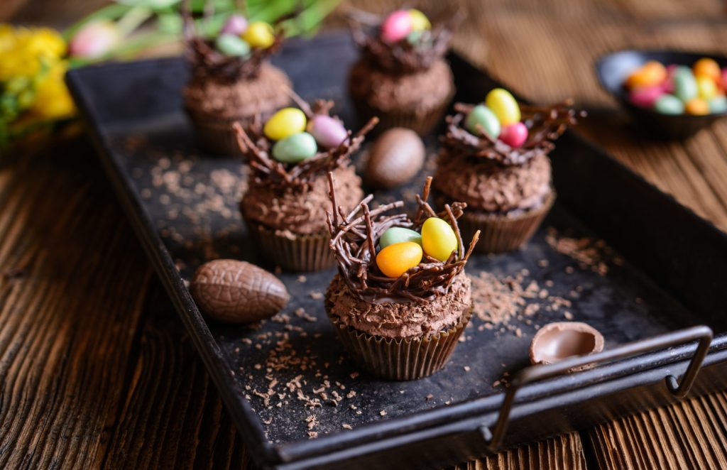 Toppings avec des oeufs de Pâques en chocolat sur des cupcakes